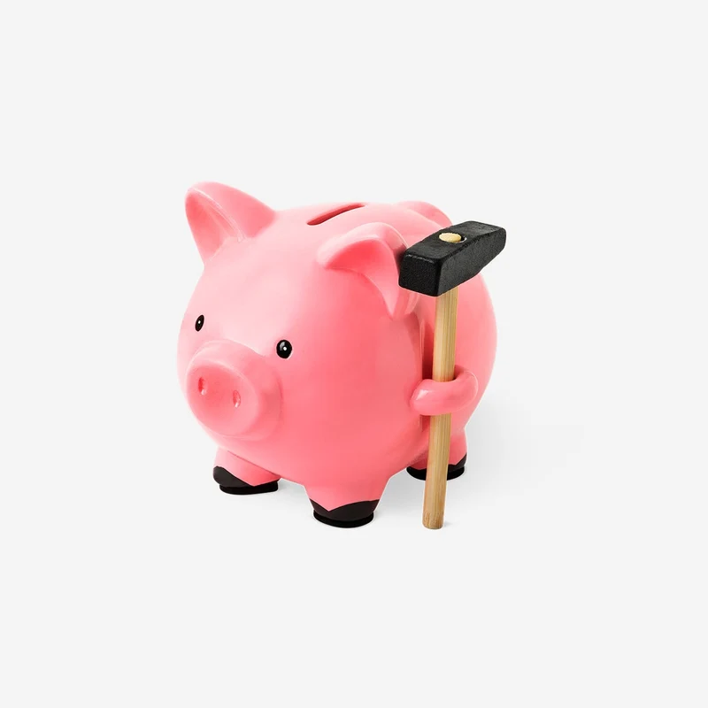 Pink piggy bank with hammer