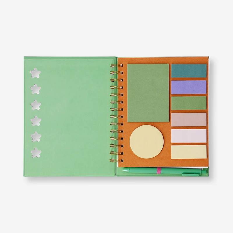 Green notebook with ballpoint pen and memos
