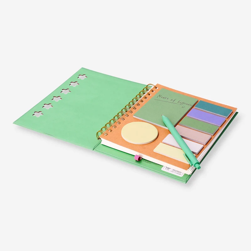 Green notebook with ballpoint pen and memos