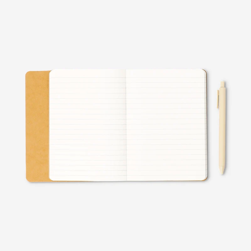 Butter yellow notebook with ballpoint pen