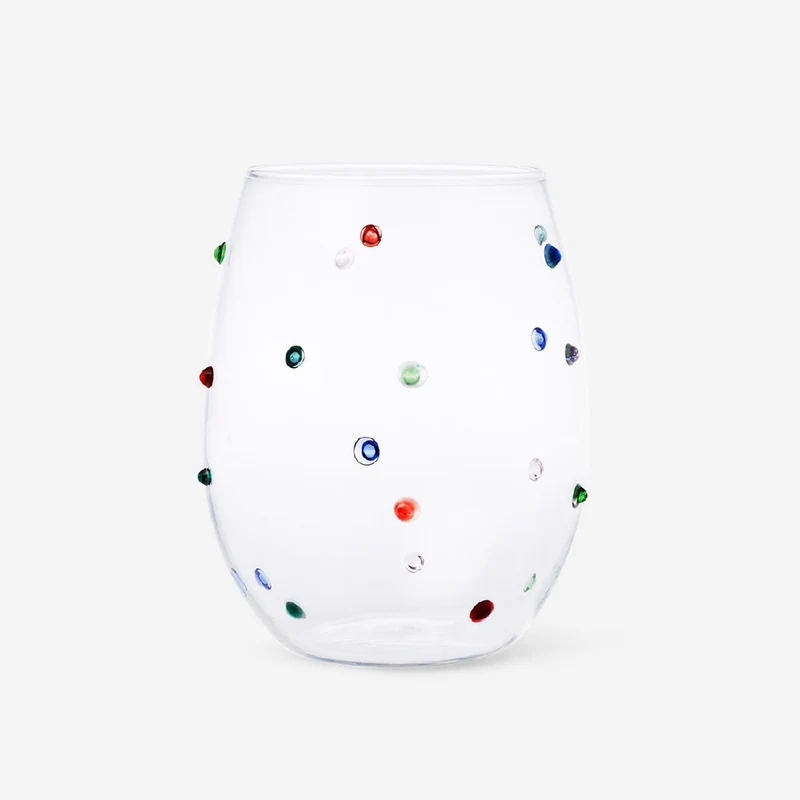 Drinking glass with multi coloured dots