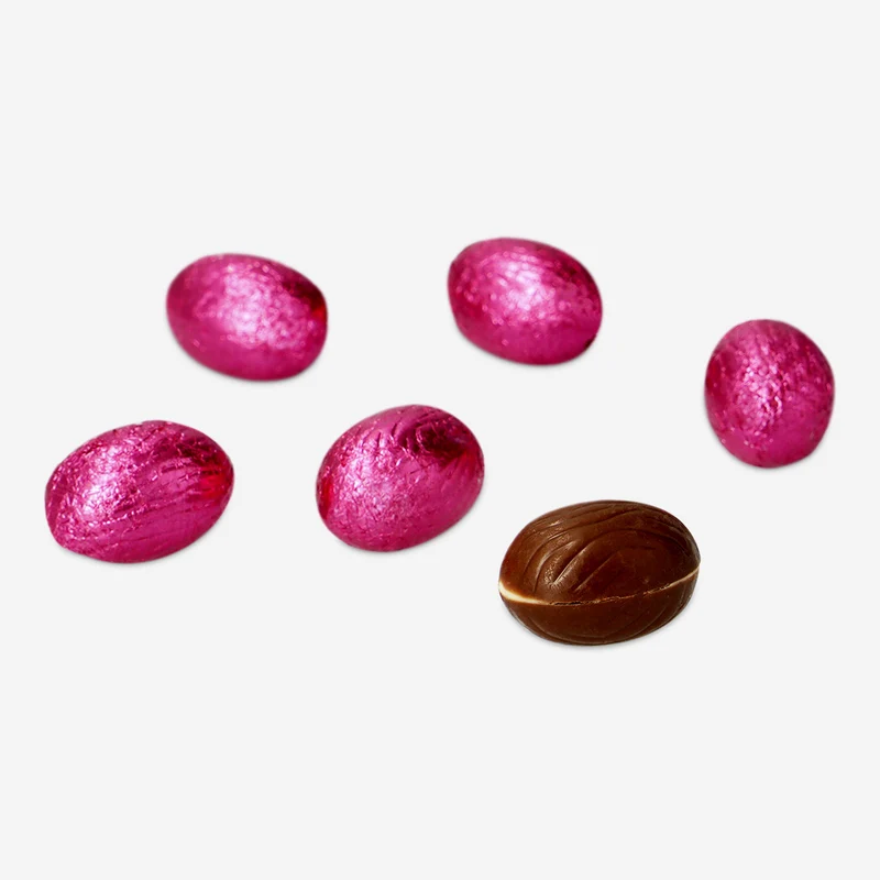 Pink milk chocolate eggs in net with milky cream filling and brownie