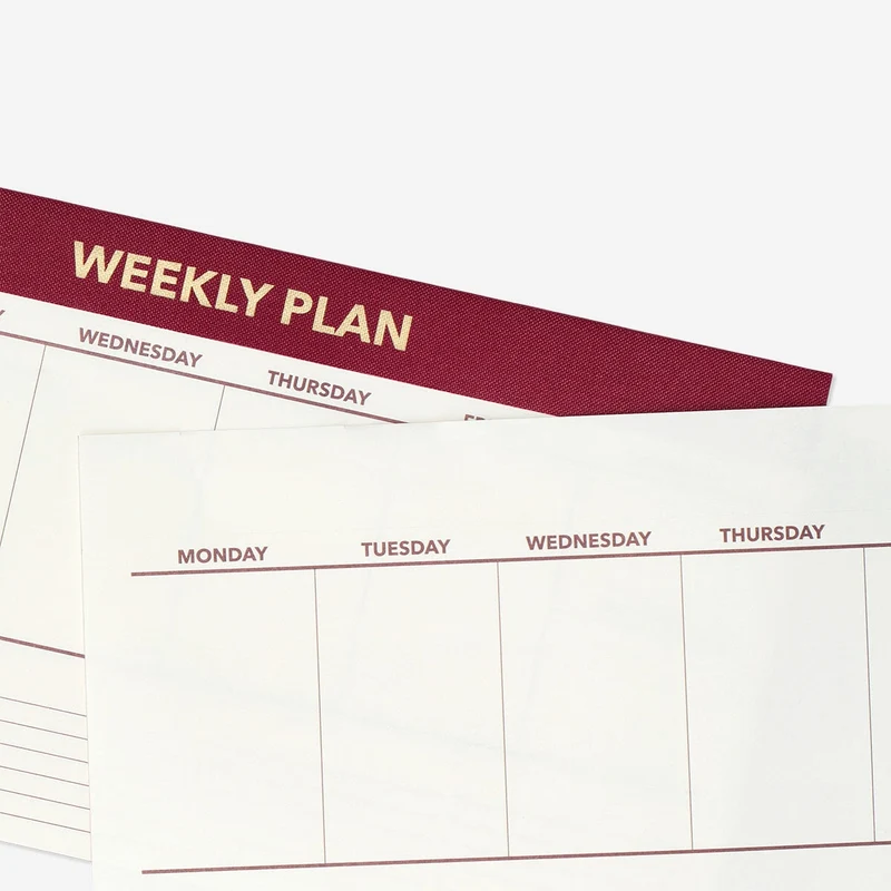 Red weekly planner for desk