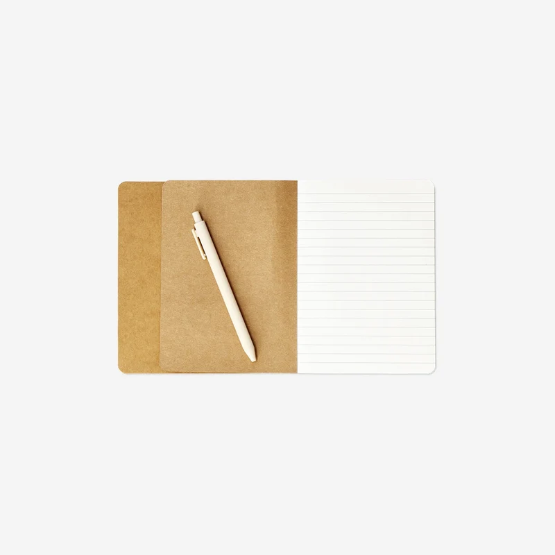 Beige notebook with ballpoint pen