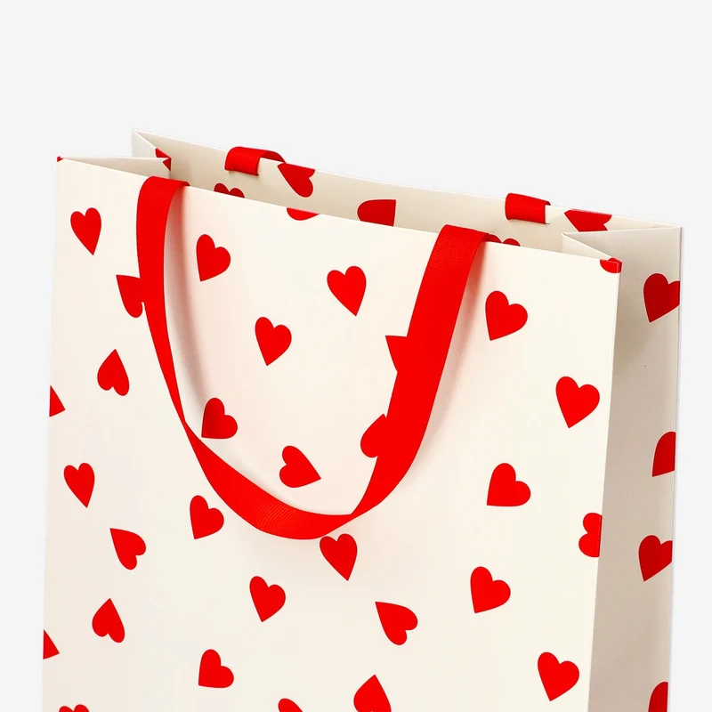 Gift bag with red hearts and handle