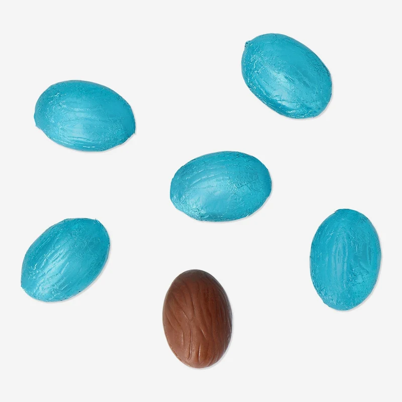 Blue milk chocolate eggs in net with popping candy
